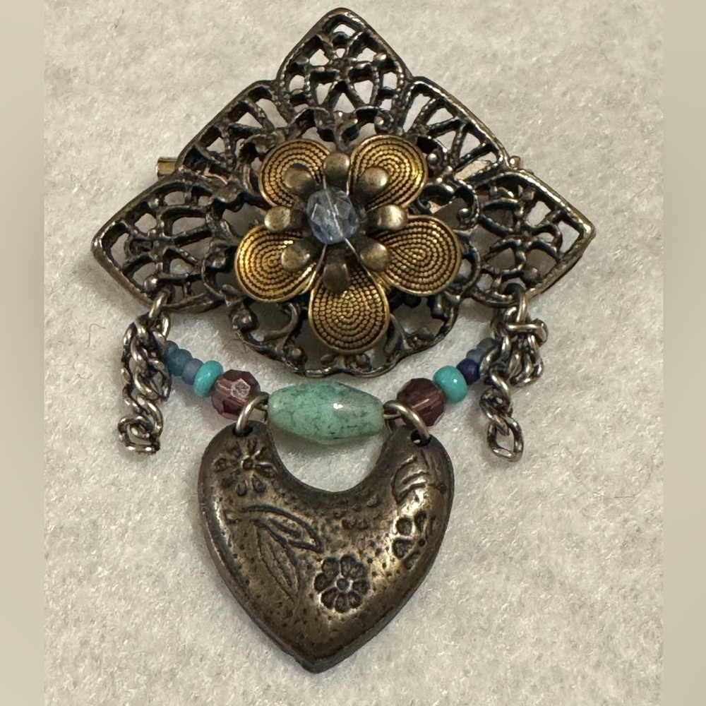 Vintage Cara Stimmel silvertone and brass flower with heart brooch